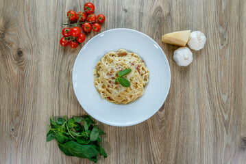 Spaghetti carbonara with ham and red cayenne pepper top view