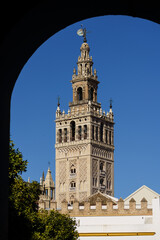 Naklejka premium The Giralda bell tower, an ancient minaret, of the Seville cathedral on a sunny day in Andalucia main city in Spain