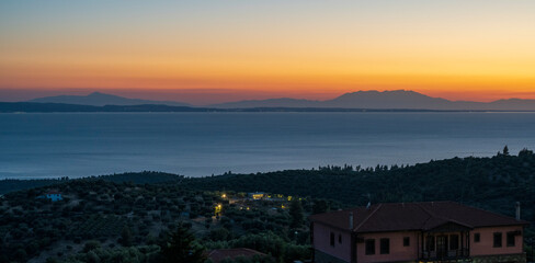 Fototapeta premium Tranquil scene of beautiful sea at sunset. Orange and yellow sunset on the sea. Aerial panoramic view of sunset over sea.