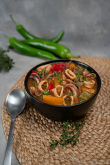 Stewed squid rings in tomato sauce for dinner
