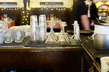 assorted glassware stacked behind the bar