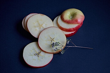 red apple slices, blue background, sliced apple, red apple, still life