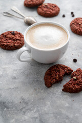 Coffee and cookies. Oat, healthy cookies and coffee cup with milk foam, breakfast concept. Copy space.