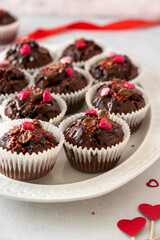 Valentine's day, chocolate homemade muffins, cupcakes with heart sprinkles.