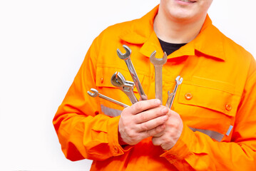 Workers' hands hold wrenches. Plumbers tools. Close-up.