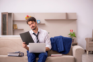 Young male employee working from home during pandemic