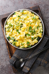Zarangollo Murciano Stewed Zucchini With Onion and scrambled closeup in the plate on the table. Vertical top view from above