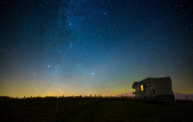 Fototapeta premium Caravan at night under the starry sky, milky way, concept for camping, galaxy, universe
