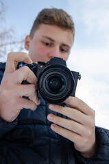 A Young European boy capturing moment with his camera.
