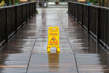 Yellow caution slippery floor sign.  Caution wet floor.