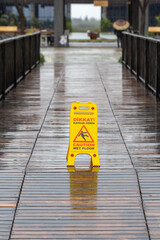 Yellow caution slippery floor sign.  Caution wet floor.