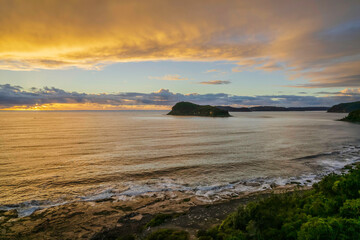 Aerial sunrise seascape with overcast sky and rain clouds