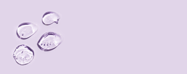 Transparent hyaluronic acid gel on a lilac background.