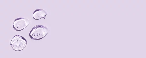  Transparent hyaluronic acid gel on a lilac background. © Anna