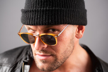 Brutal angry gang man lifestyle, serious handsome guy. Close up portrait of guy with serious...