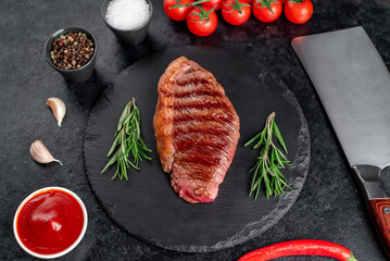 grilled picanha steak with spices on a dark background