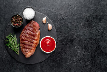 grilled picanha steak with spices on a dark background with copy space for your text