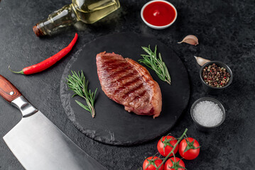 grilled picanha steak with spices on a dark background