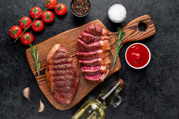 
grilled picanha steak with spices on a stone background
