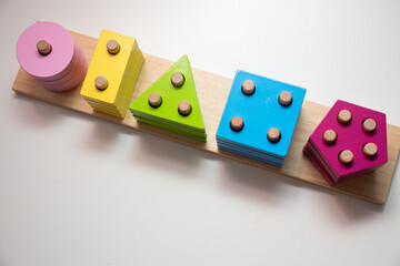 Children's toys. Logic game for kids. Happy child and fun Games. Day and Night is a fun-filled game of logic. Colourful wooden blocks. Bricks with the pyramid. High quality photo