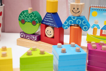 Children's toys. Logic game for kids. Happy child and fun Games. Day and Night is a fun-filled game of logic. Colourful wooden blocks. Bricks with the pyramid. High quality photo