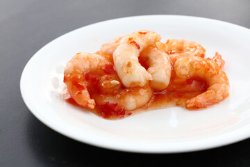 Portion of shrimps with chili sauce on plate