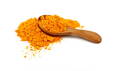 Wooden scoop spoon full of yellow turmeric powder