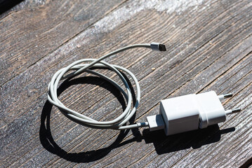 Cable phone chargers on wood background