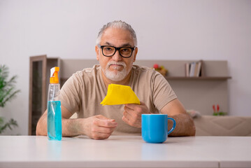 Old man doing housework at home