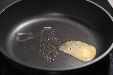 Butter melting on a hot non-stick surface of a metal pan