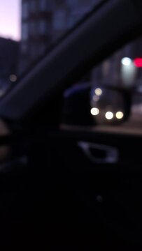 Street Lights and colorful traffic lights from the car. Night Blur Bokeh Abstract. Urban atmospheric mood. Vertical video stock footage