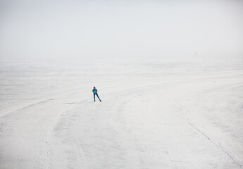 ice skater on a frozen lake in the mountains