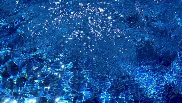 Sunbeams reflected in blue pool