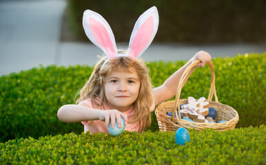 Happy easter bunny child boy. Spring kids holidays concept. Child gathering eggs, easter egg hunt concept.