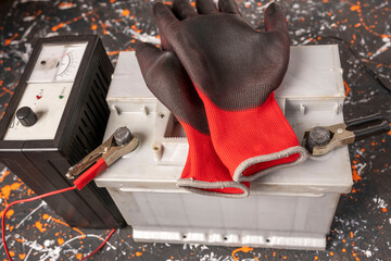 The process of charging the car battery, the terminals of the 12V car battery, the charger