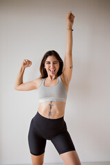 Young fitness woman trains at home