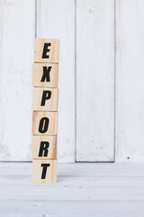 wooden cube, with the word export, with white wooden background