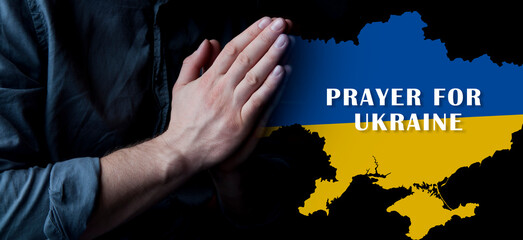 Hands in prayer. Prayer for Ukraine. Ukrainian flag. Prayer for the whole world. Europe and...