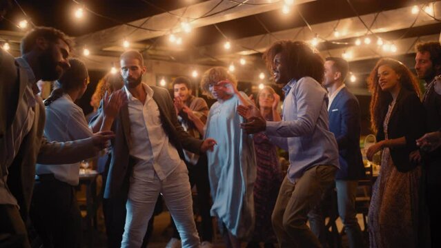 Beautiful Carefree Friends are Dancing Together and Celebrating an Evening Event at a Party. Diverse Multiethnic Young Adult People Have Fun at a Corporate Party in a Restaurant.
