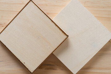 shallow wooden boxes upside down on a wooden surface