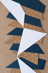 abstract paper background mostly composed with triangular shaped paper in white, blue, or brown