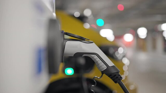Slow Motion electric vehicle in underground car park on charge