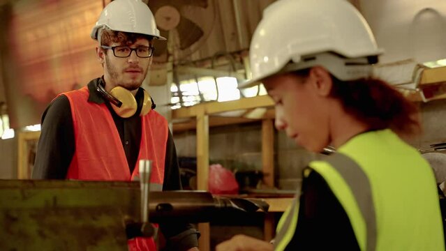 Factory engineers and buddy are inspecting machines inside an industrial plant,workplace safety idea
