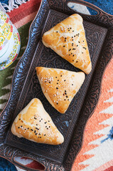 Samsa, national savory baking, usually with minced meat, cheese or vegetables as a filling, an oriental meal, Central Asia cuisine concept.