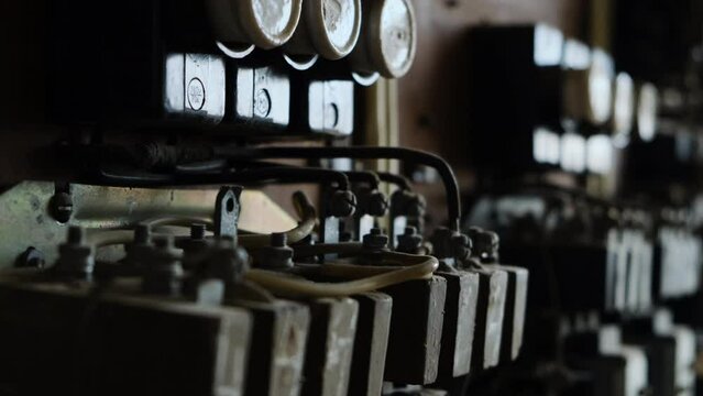 old vintage cabinet with relay or power switch for machine tools in abandoned factory. Retro transistors and resistors close-up view.