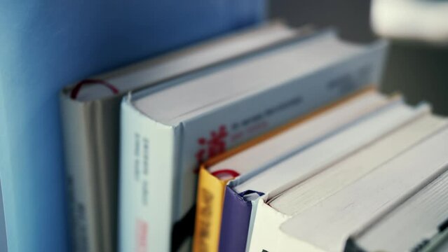 Extreme close-up view of shelf with books.