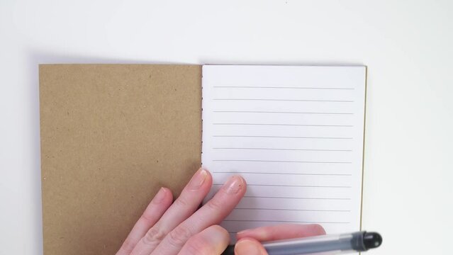 flat lay to do list write in notebook with black pen or felt-tip pen. Make to-do list on a sheet. Place for text. Top view of working white table. To do list in notebook with office suppliers on desk.