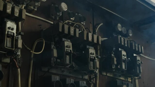 old vintage cabinet with relay or power switch for machine tools in abandoned factory. yellow light flashes to indicate danger. Retro transistors and resistors close-up view.