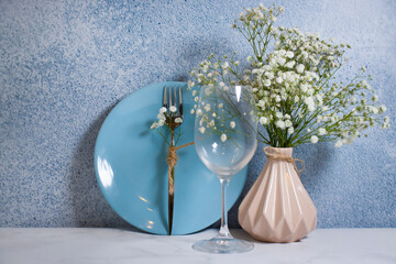 gypsophila flower plate in a vase on a brick background