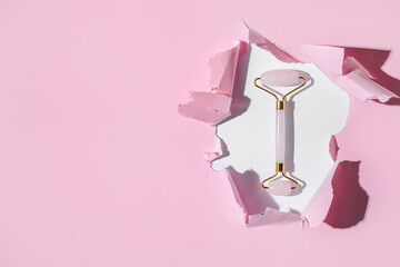 Face massage roller with torn paper sheet, top view